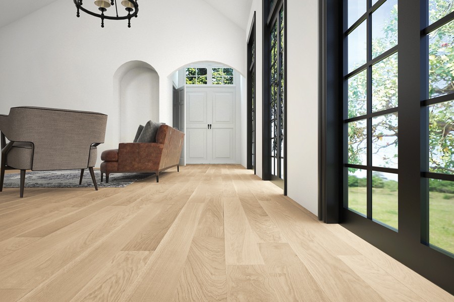 Hardwood floors in a living with floor to ceiling windows by Carpet to Go in Bellevue, WA.